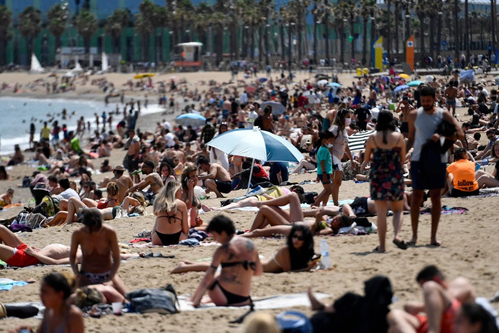 Sunbathers at Barceloneta Beach in Barcelona on June 6. Spain is allowing all vaccinated travellers to visit from June 7, as the tourism hotspot aims to revive its virus-battered travel industry. Photo: AFP