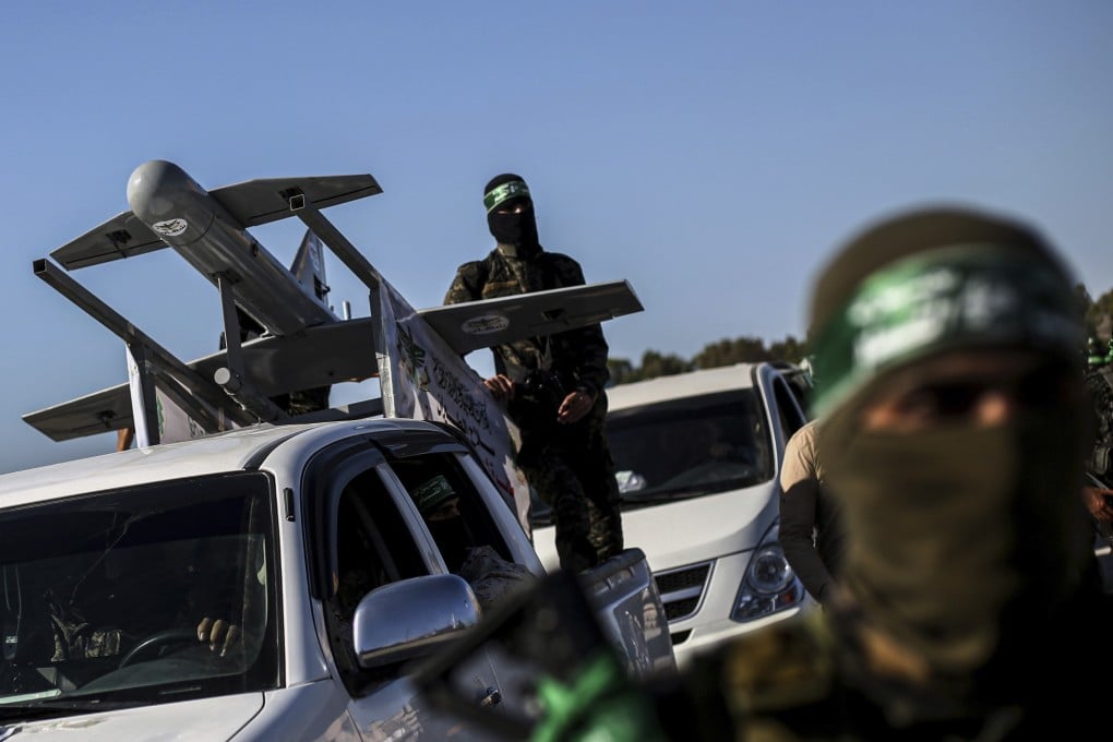 Palestinian Hamas masked gunmen parade with a drone on the back of a truck through the streets of a town in the southern Gaza Strip last month. Photo: AP