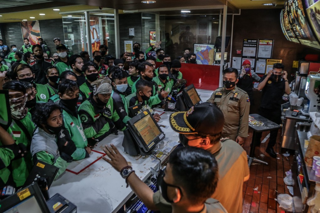 Indonesian food delivery riders queue up at a McDonald’s outlet in Bogor to buy the BTS meal deal for customers. Photo: AFP