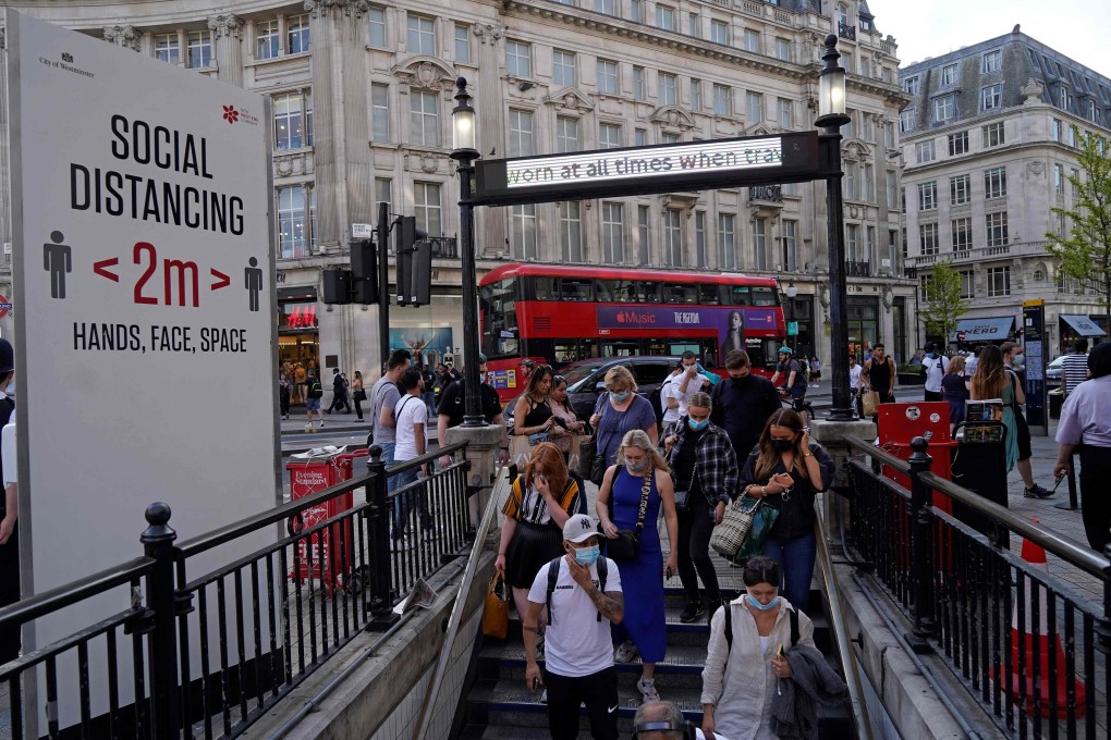 Commuters enter Oxford Circus London Underground station in London. Photo: AFP