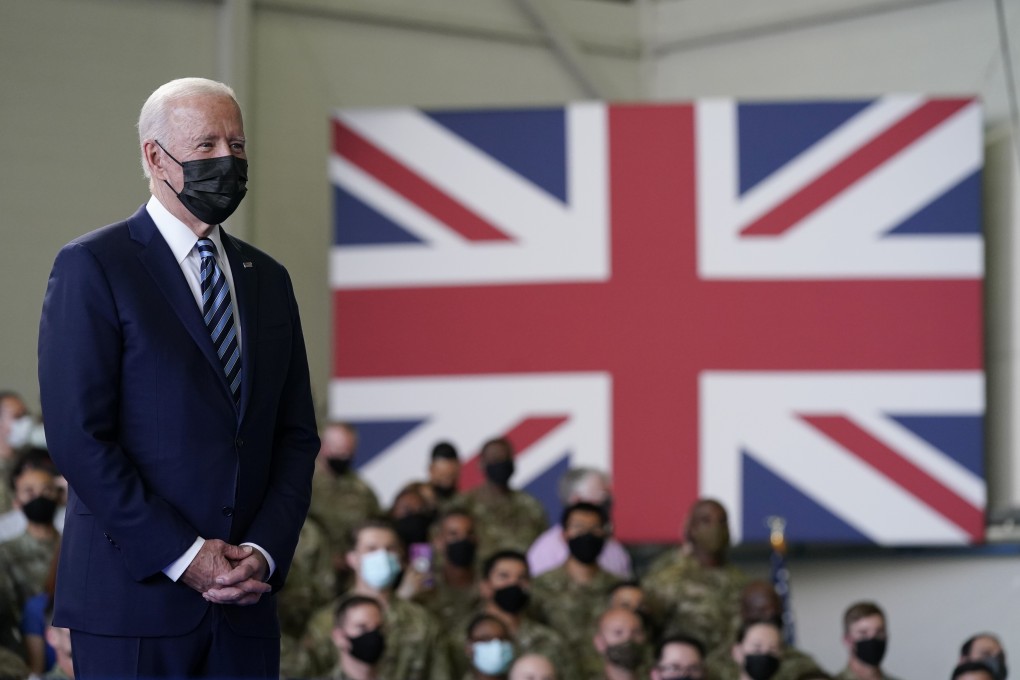 President Joe Biden listens as first lady Jill Biden speaks to American service members at RAF Mildenhall in Suffolk, England. Photo: AP