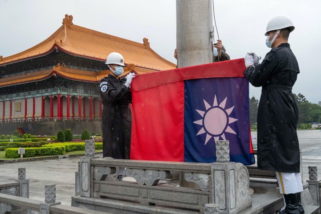 Honour guards raise a Taiwanese flag in Taipei. Photo: Bloomberg
