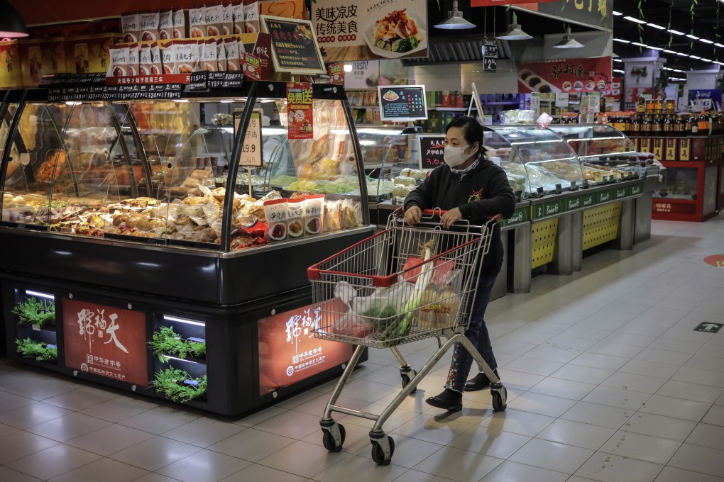 A woman shops in a supermarket in Beijing. In China, factory gate inflation has accelerated to 9 per cent but consumer price inflation stands at 1.3 per cent for May. Photo: EPA-EFE