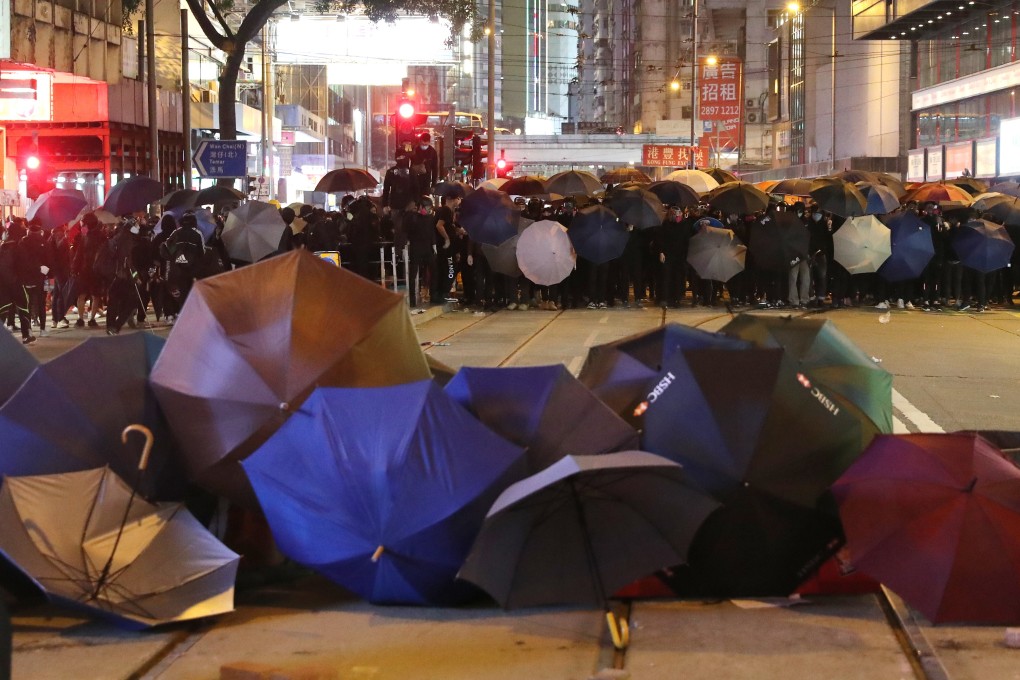 Protesters take cover under umbrellas on New Year's Day in 2020. Photo: Sam Tsang