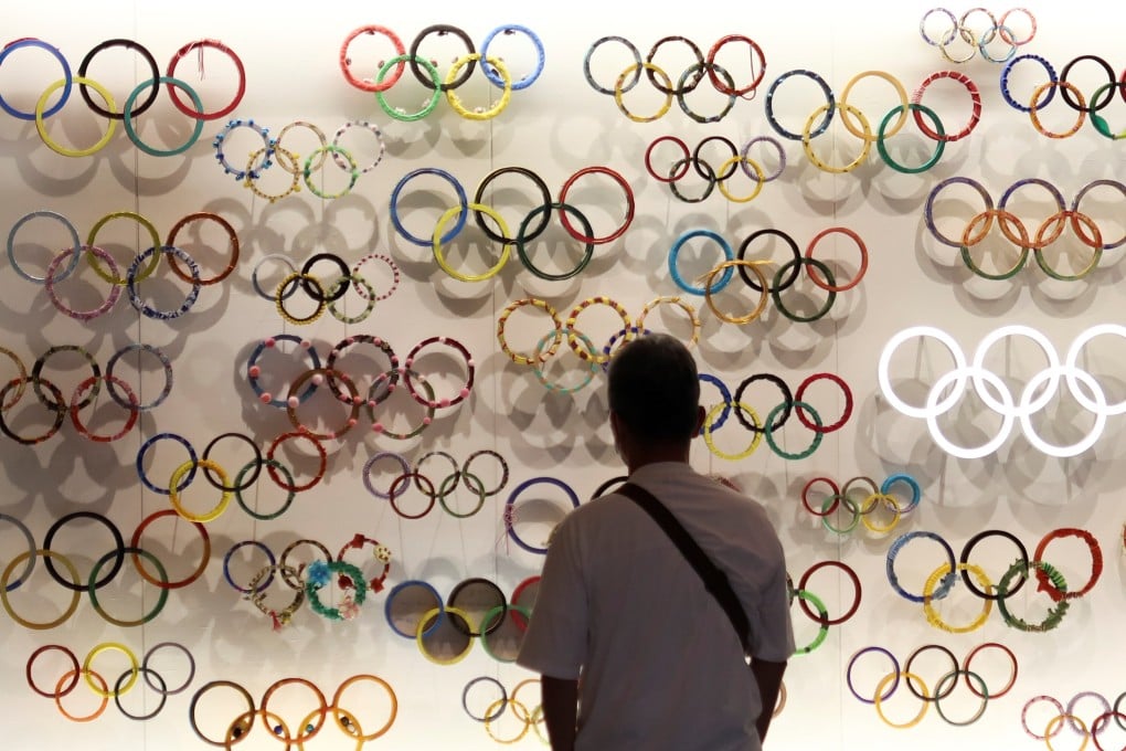 A man looks at the Olympic Rings at the Japanese Olympic Museum near the National Stadium in Tokyo, Japan. Photo: Reuters
