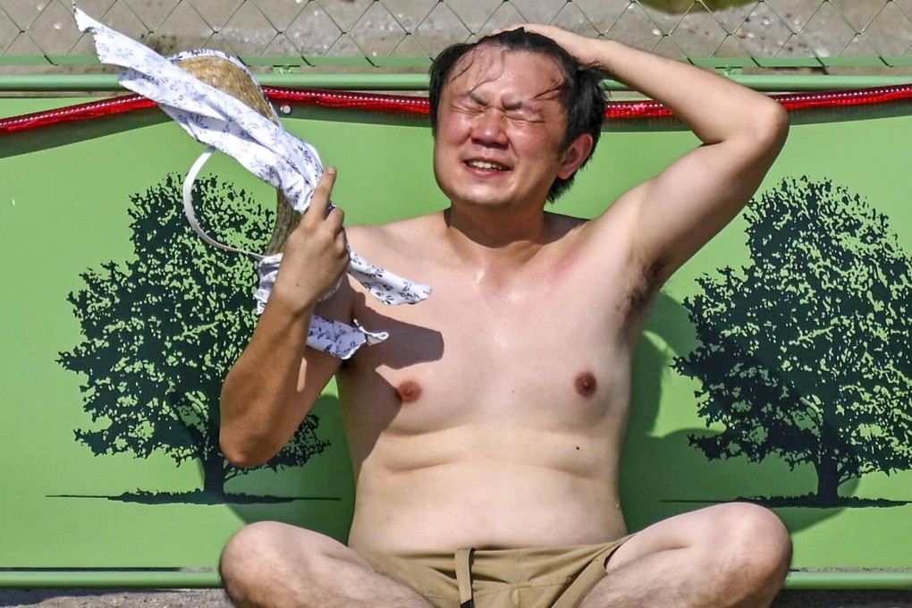 People sit at Odaiba beach in Tokyo Bay during a summer heatwave in August, 2020. File photo: AFP