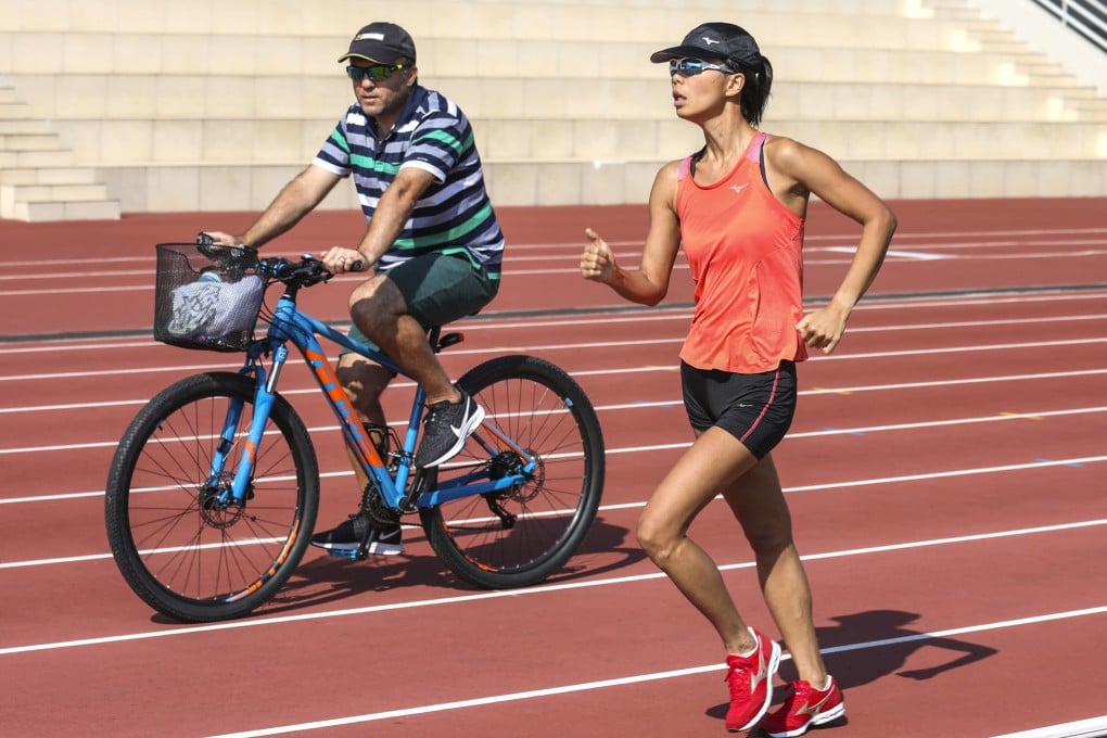 Race walker Ching Siu-nga with head athletics coach Anthony Giorgi at the Sports Institute in Fo Tan. Ching is likely to obtain a ticket to Tokyo when the Olympic qualification ends next week. Photo: Nora Tam