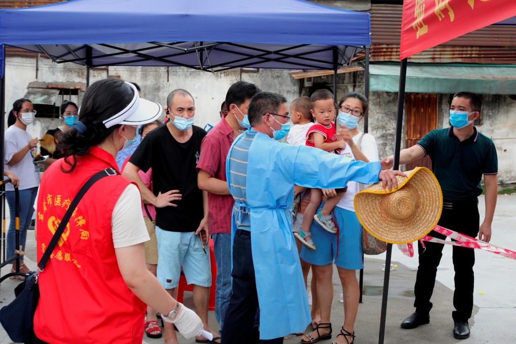 Residents line up to get tested in Dongguan on Monday. Health experts have expressed concern about new variants like Delta. Photo: Reuters