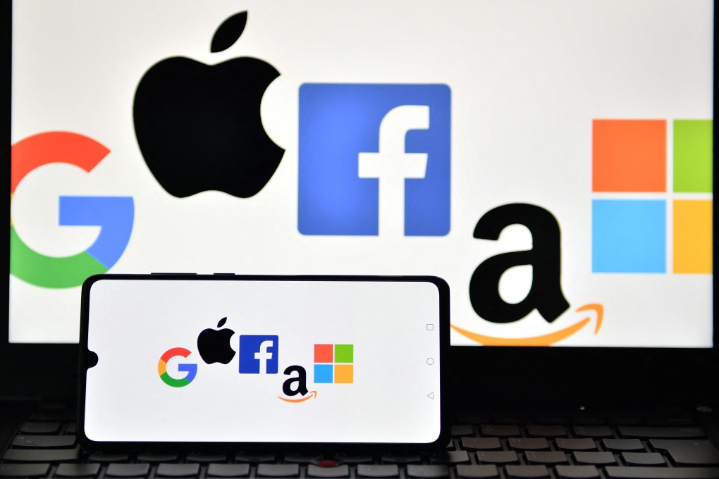 An illustration picture taken in London shows the logos of Google, Apple, Facebook, Amazon and Microsoft displayed on a mobile phone and a laptop screen on December 18, 2020. US lawmakers are questioning whether Microsoft, one of the most valuable companies in the world, is receiving the same level of scrutiny as other Big Tech companies. Photo: AFP