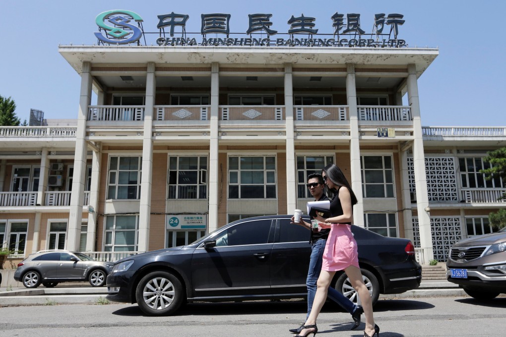 People walk past a branch of China Minsheng Bank in Beijing. Photo: Reuters