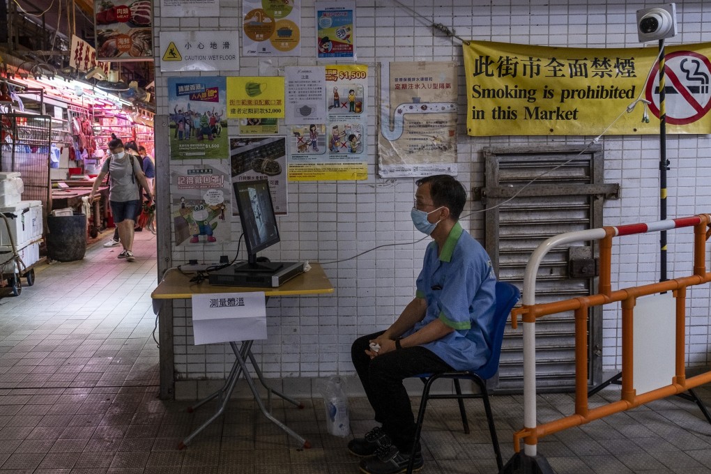 A worker is seen manning a body temperature checkpoint at the entrance to a wet market in Hong Kong. File photo: NurPhoto via Getty Images