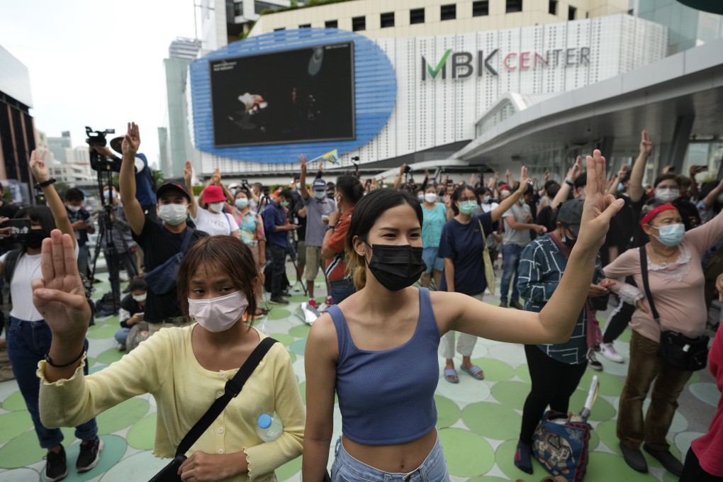 Pro-democracy supporters display the three-fingered symbol during a demonstration in Bangkok. photo: AP