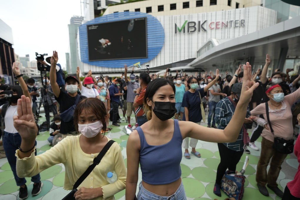 Pro-democracy supporters display the three-fingered symbol during a demonstration in Bangkok. photo: AP