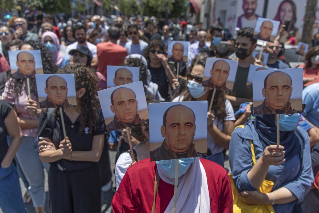 Angry demonstrators carry pictures of Nizar Banat during a rally protesting his death, in the West Bank city of Ramallah. Photo: AP
