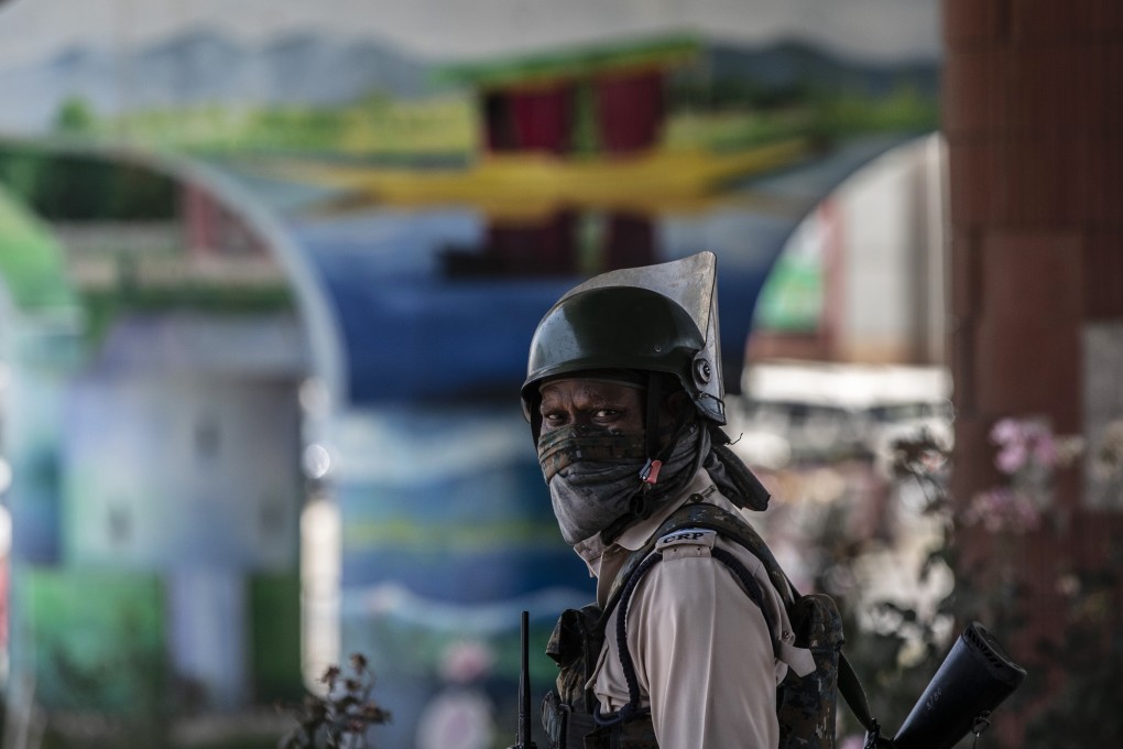 An Indian paramilitary soldier stands guard beneath a flyover in Srinagar, Indian-controlled Kashmir, ahead of a meeting between the Modi administration and politicians from the region. Photo: AP