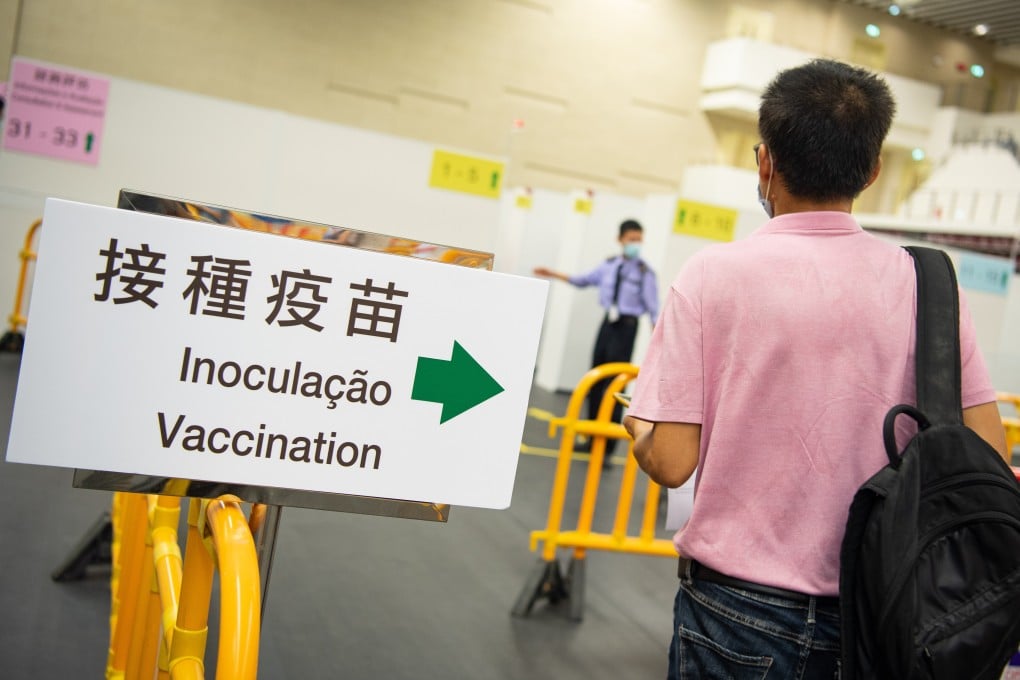 A man waits to receive the Covid-19 vaccine at the Mong Ha sports complex in Macau on Monday. Photo: Xinhua