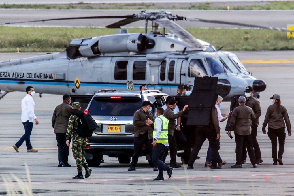 Colombia’s President Ivan Duque, fourth from right, and bodyguards near the presidential helicopter at Camilo Daza International Airport after it was hit by gunfire in Cucuta, Colombia on Friday. Photo: Colombian Presidency / AFP
