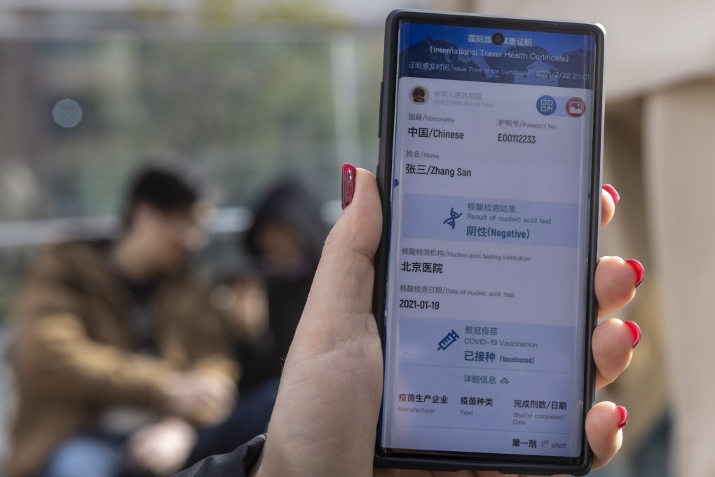 A woman showcases the new China international travel health certificate app, Shanghai, China, 10 March 2021. Photo: EPA-EFE
