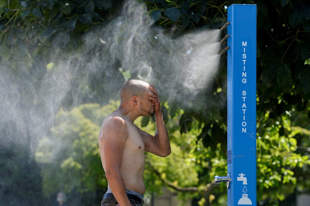 A man cools off at a misting station in Vancouver, British Columbia, Canada. Photo: Reuters