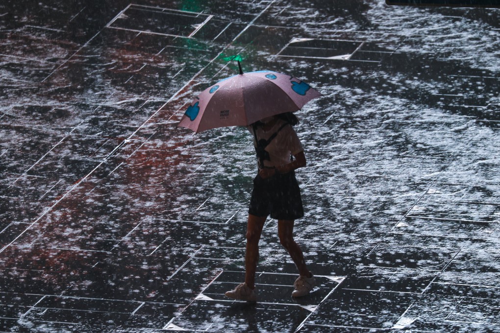 A woman walks through Central after Hong Kong’s first black rainstorm warning of the year was issued at 8.20am on Monday. Photo: Dickson Lee