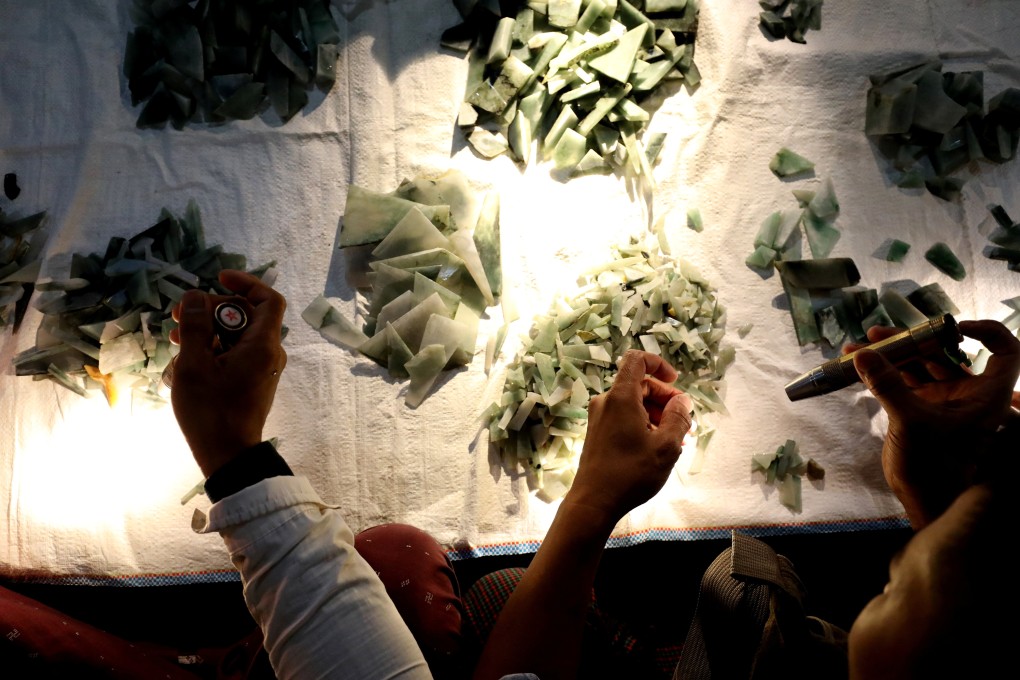 Buyers inspect pieces of jade at a market in Mandalay, Myanmar. Photo: Reuters