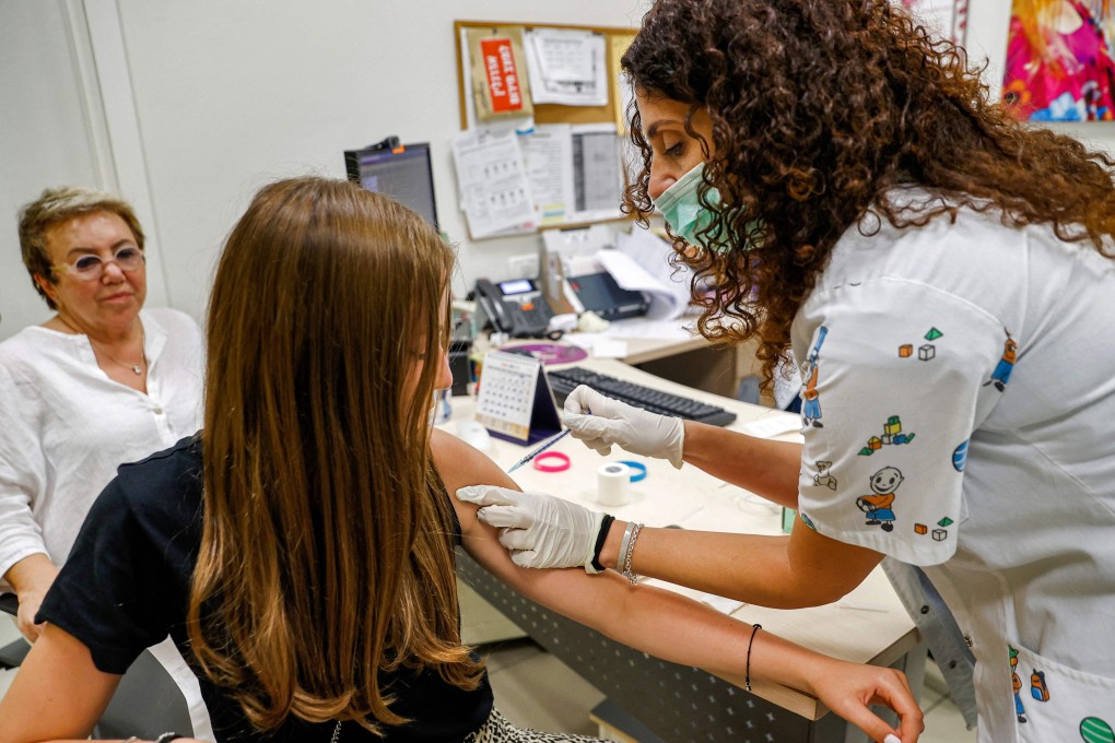 A teenage girl receives a dose of the Pfizer Covid-19 vaccine in Holon, Israel. Photo: AFP