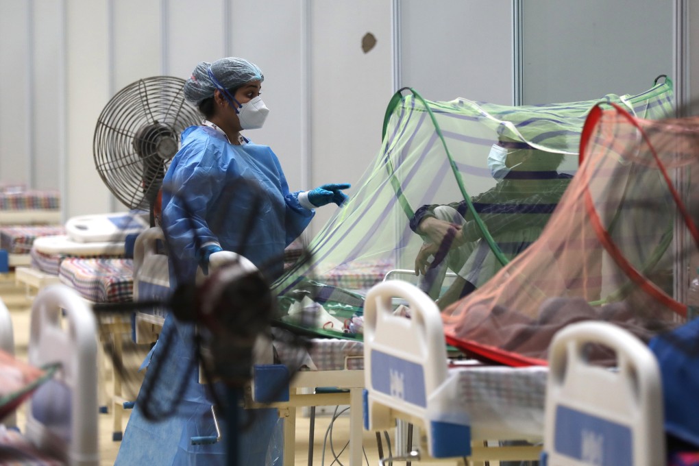 An Indian doctor examines patients inside a Covid-19 care centre in New Delhi. Photo: EPA