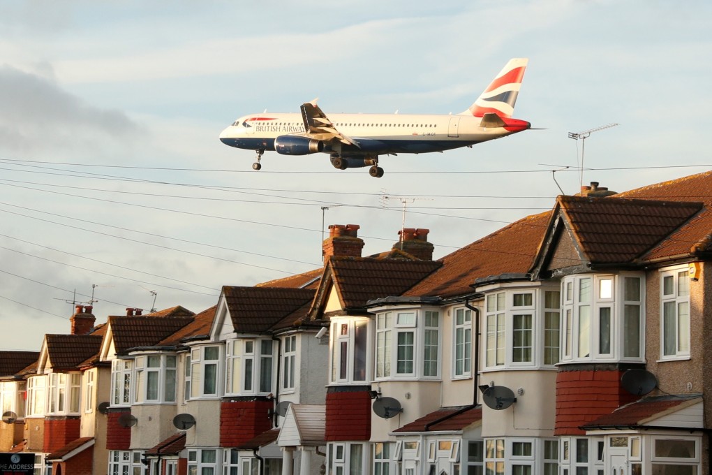 A British Airways plane passes over homes in Myrtle Avenue as it comes in to land at Heathrow Airport, London. Photo: Reuters