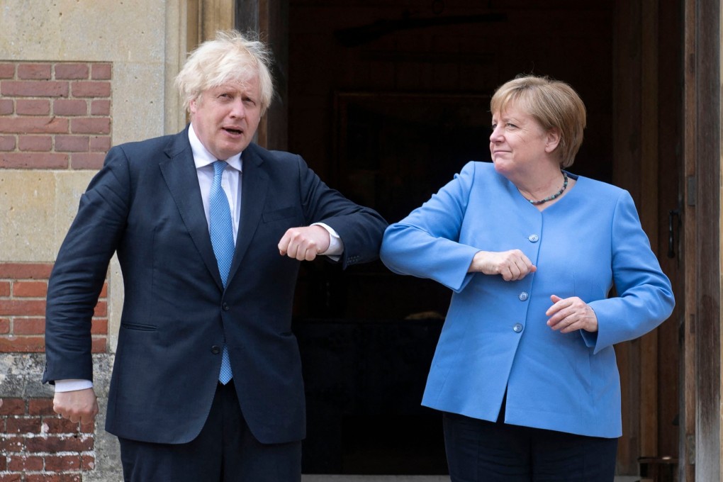 Britain’s Prime Minister Boris Johnson welcomes German Chancellor Angela Merkel on her arrival at Chequers, Buckinghamshire on Friday. Photo: AFP