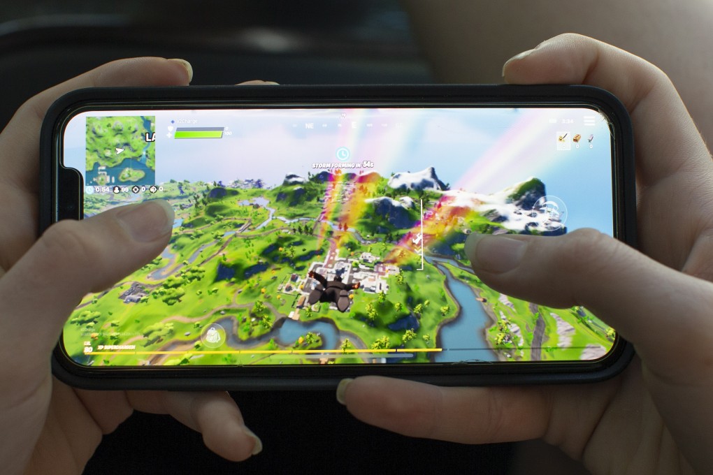 A teenage girl plays the video game Fortnite, on an Apple iPhone X in Billerica, Massachusetts, on August 24, 2020. Tencent owns nearly half of Epic Games, an investment now facing scrutiny in the US. Photo: EPA-EFE