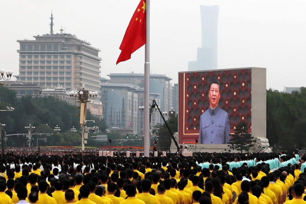 President Xi Jinping, seen on a giant screen, sings the national anthem during a flag-raising ceremony at the Tiananmen Square event on Thursday. Photo: Reuters
