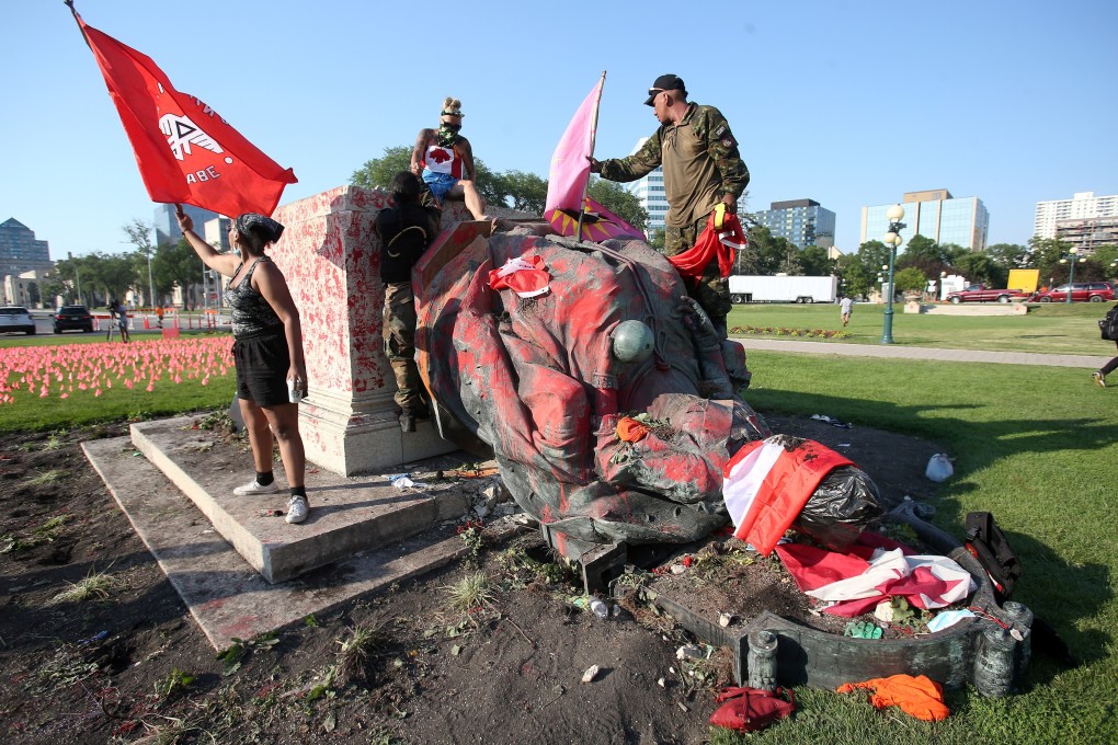 A defaced statue of Queen Victoria lies after being toppled during a rally in Winnipeg, Canada. Photo: Reuters