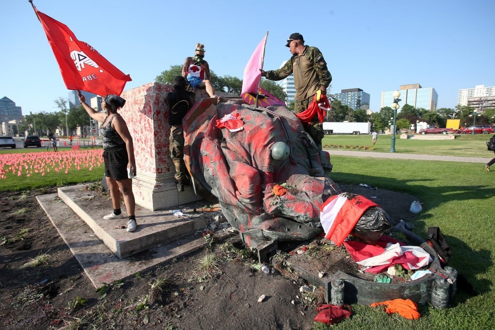A defaced statue of Queen Victoria lies after being toppled during a rally in Winnipeg, Canada. Photo: Reuters