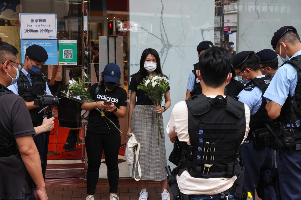 Police stop and search people in Causeway Bay, especially those holding flowers, a day after an officer was knifed in the area, with the attacker stabbing himself afterwards. Photo: K. Y. Cheng