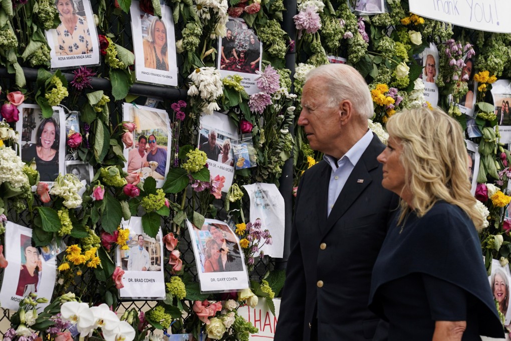 US President Joe Biden and first lady Jill Biden visit a memorial wall covered in flowers and photos of the missing on Thursday after a block of flats collapsed in Surfside, Florida. Photo: Reuters