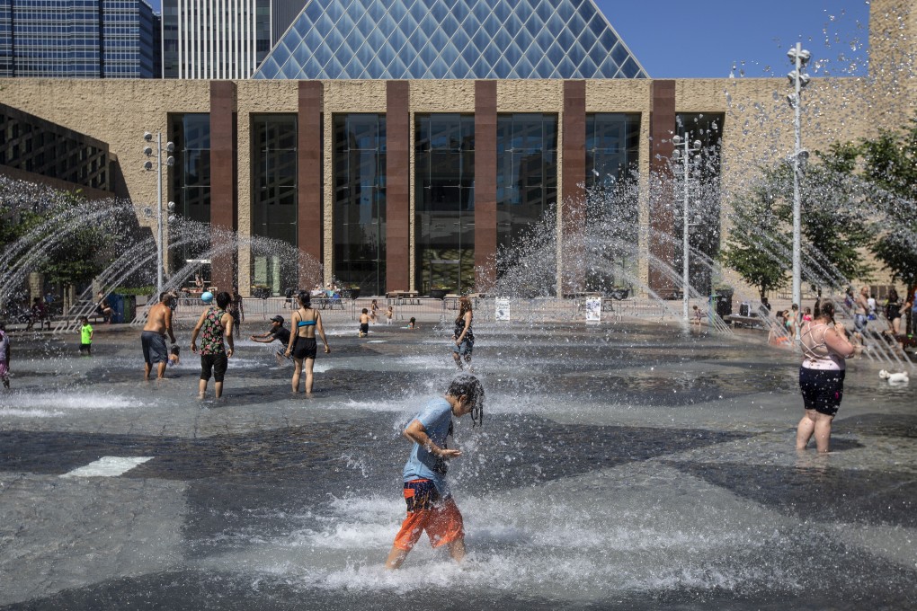 Canadians cool off in the city hall pool as temperatures hit 37 degrees Celsius in Edmonton, Alberta. Photo: The Canadian Press via AP