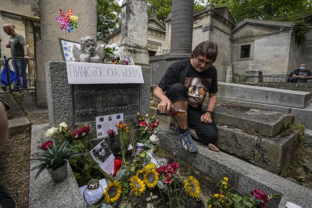 A German fan pours whisky on the tomb of musician Jim Morrison at the Pere Lachaise cemetery in Paris on Saturday. Photo: AP