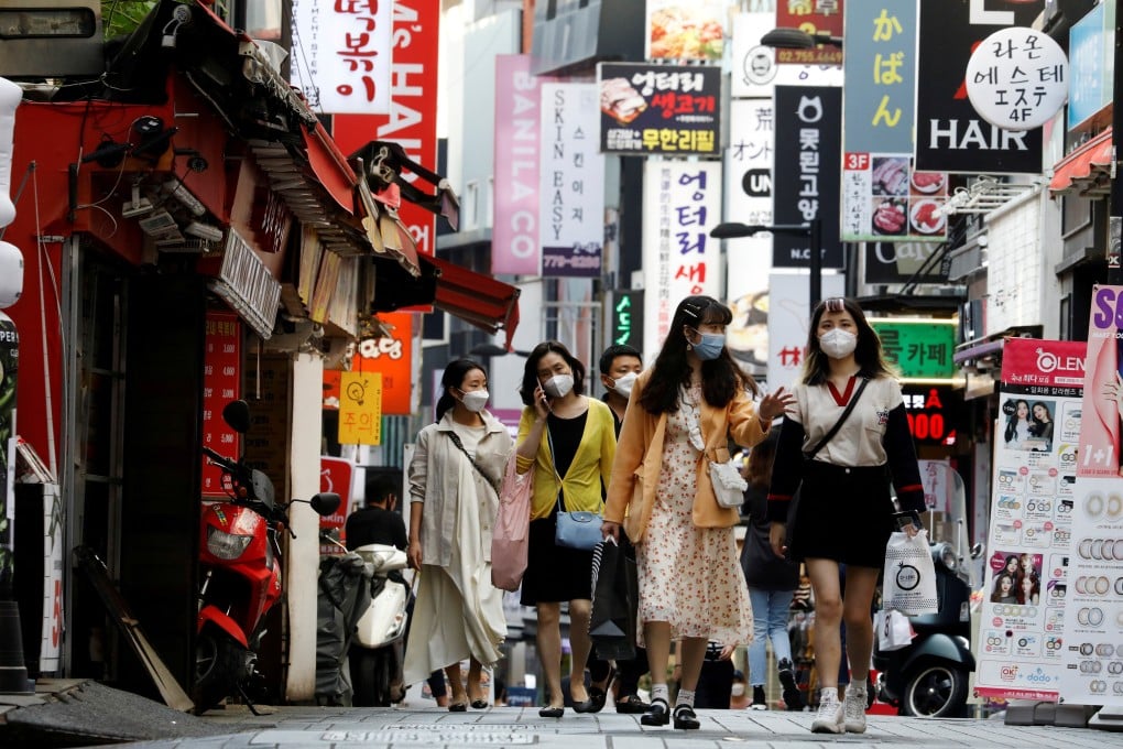 People walk through the Myeongdong shopping district of South Korean capital Seoul in May. Photo: Reuters