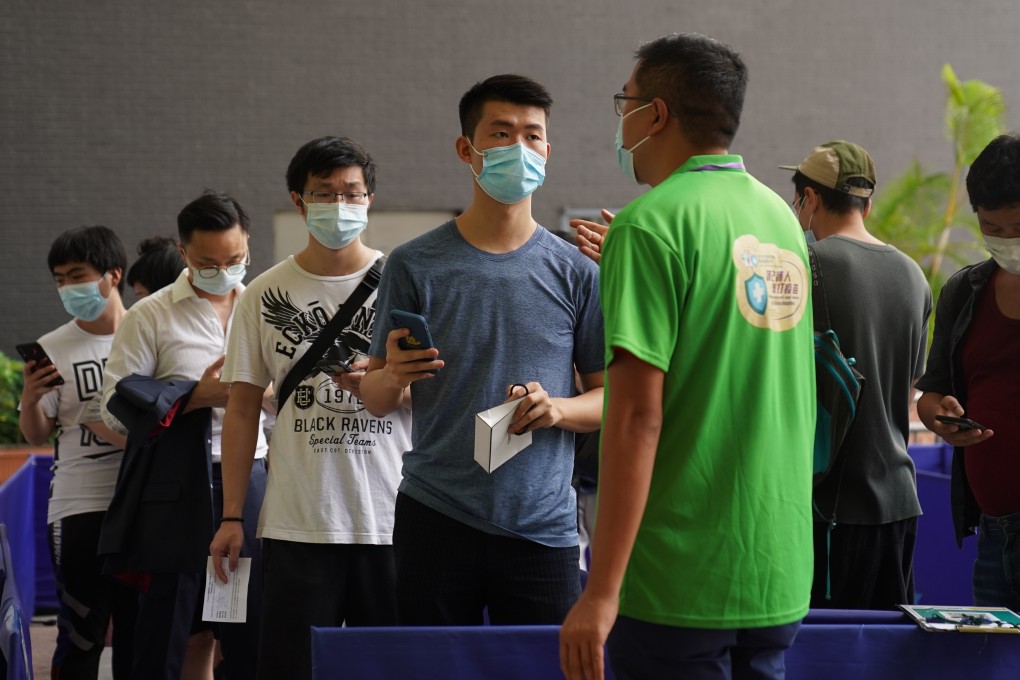 People queue at the vaccination centre at Sun Yat Sen Memorial Park Sports Centre. Photo: Sam Tsang