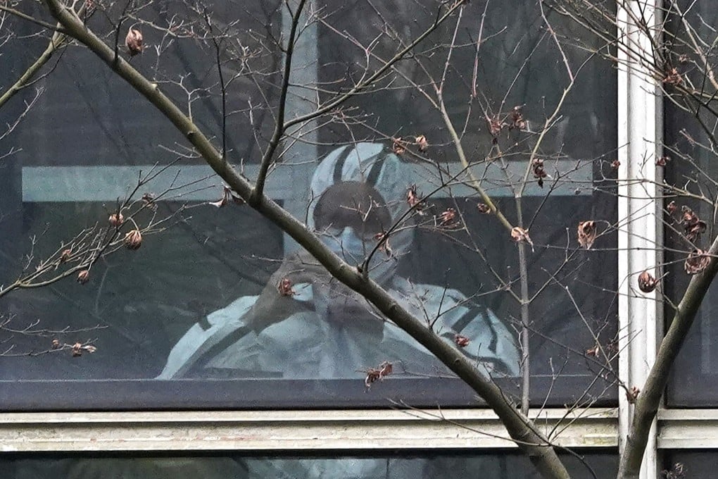 A World Health Organization employee wears protective gear during a field visit to Wuhan in central China’s Hubei province. Photo: AP
