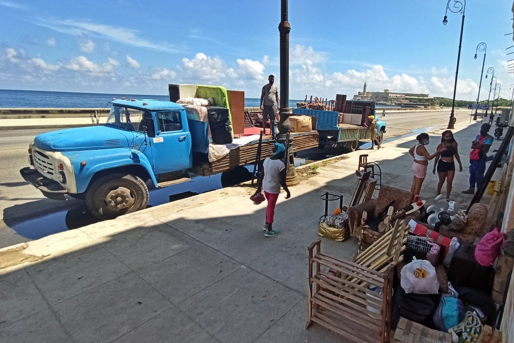 Residents in Havana’s Malecon promenade in Cuba evacuate before the arrival of Tropical Storm Elsa on Sunday. Photo: EPA-EFE