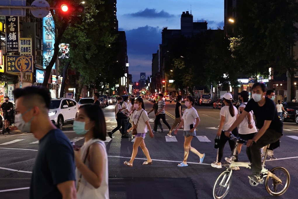 People head towards a newly reopened night market in Taipei on Friday. Photo: Reuters