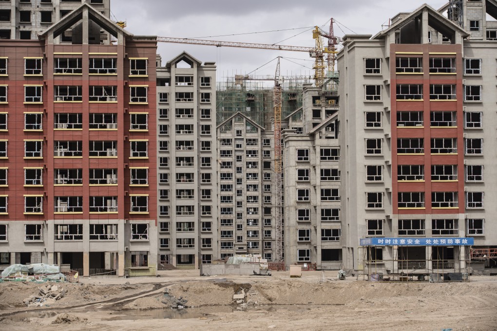 Residential buildings under construction in the new city area of Yumen, Gansu province. Warburg is tapping into a growing sector of distressed asset investment as more Chinese property companies feel the strain from tighter liquidity and policy curbs. Photo: Bloomberg