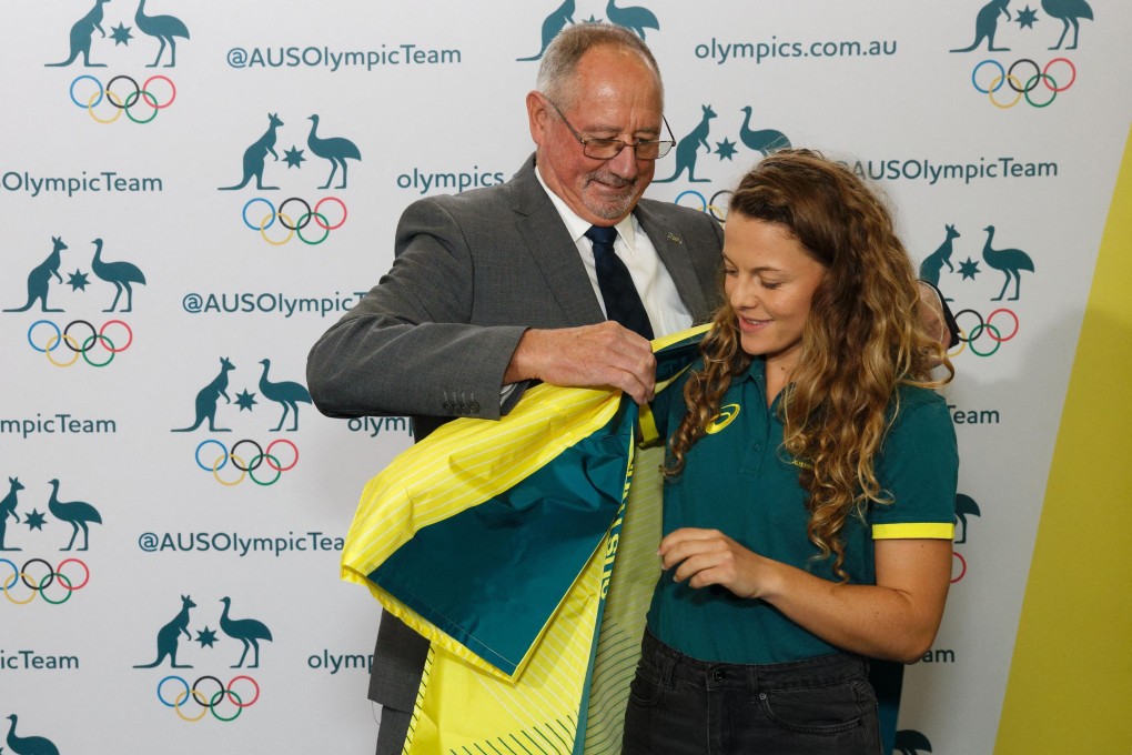 Rosie Malone is presented with her team kimono by Hockey Australia official Pat Hall after being named as a member of the Australian women’s hockey team for the Tokyo 2020 Olympics. Photo: AFP