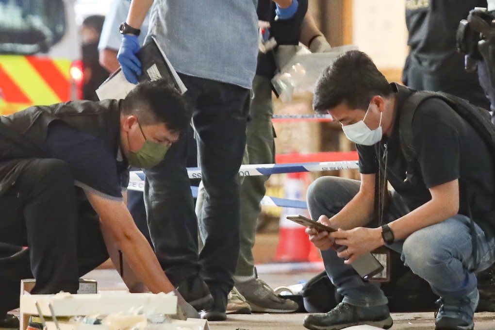 Police gather evidence at the crime scene outside Sogo in Causeway Bay. Photo: Xiaomei Chen