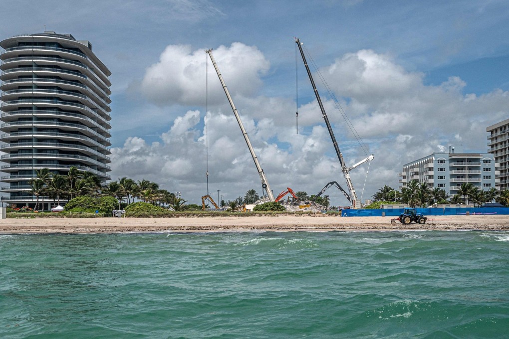 Cranes are seen where the 12-storey Champlain Towers South condo stood. The remainder of the building was demolished on Sunday night. Photo: AFP