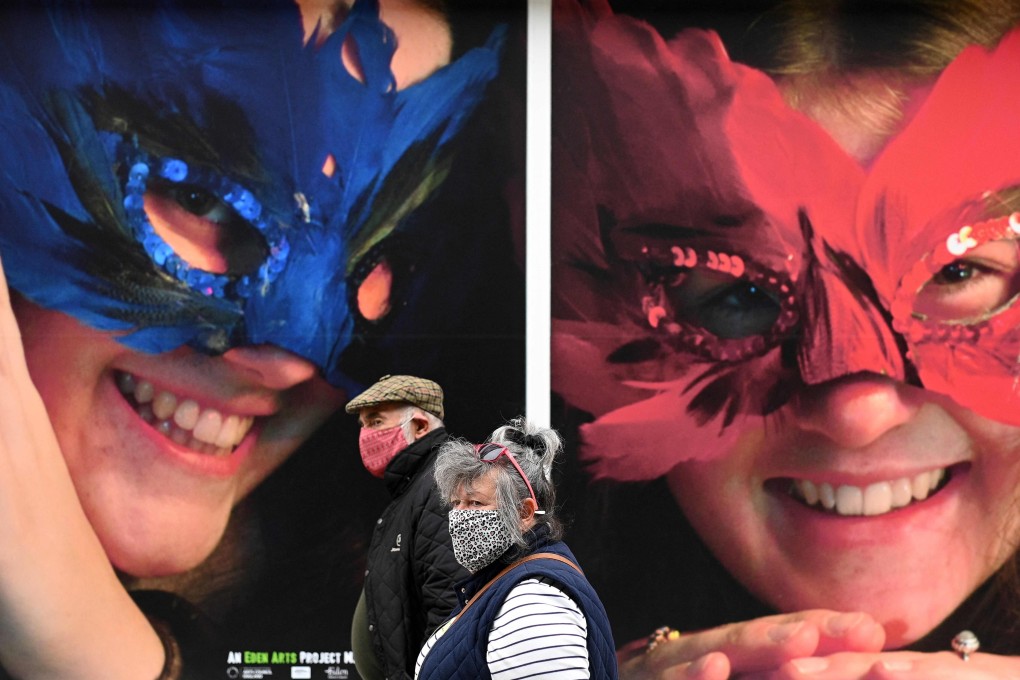 Pedestrians wear face masks in Penrith in Cumbria, north west England. Photo: AFP