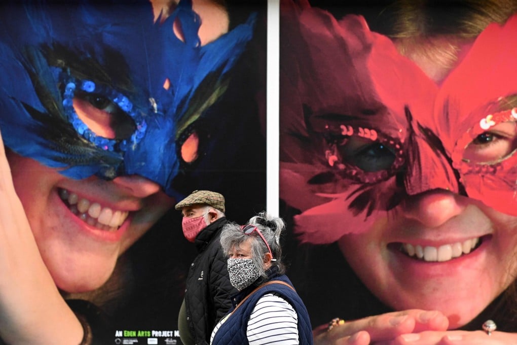 Pedestrians wear face masks in Penrith in Cumbria, north west England. Photo: AFP