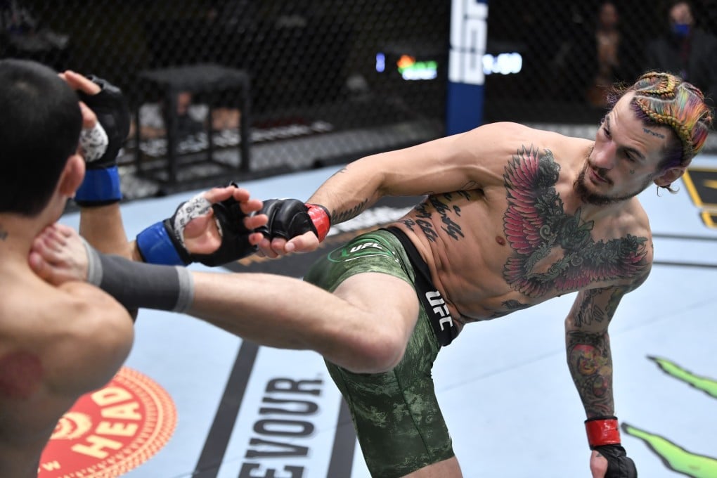 Sean O’Malley kicks Thomas Almeida in their bantamweight fight at UFC 260. Photo: Jeff Bottari/Zuffa LLC