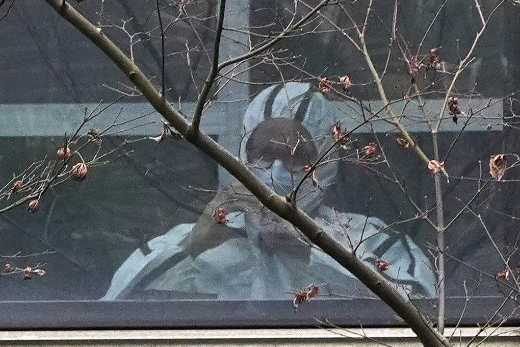 A member of the WHO-backed team visits an animal disease control and prevention centre in Hubei, China in February. Scientists urged the WHO to “expeditiously” continue the investigation. Photo: AP